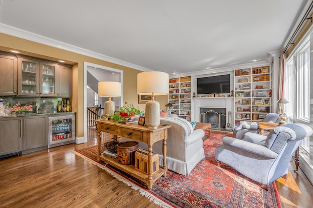 1775 Mooreland Dr, Lexington, KY 40502 - living room with beverage cooler, bar area, a fireplace, ornamental molding, and wood finished floors