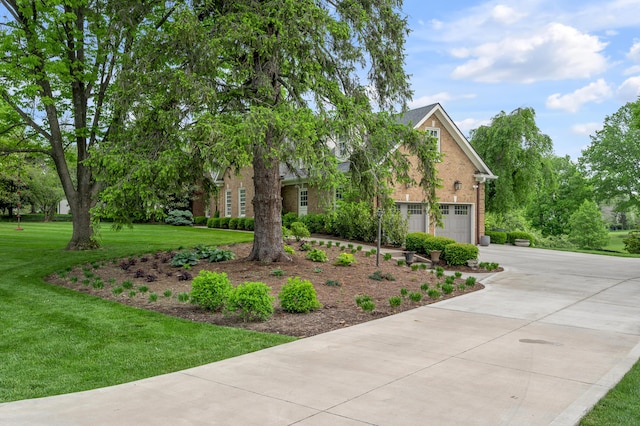 1775 Mooreland Dr, Lexington, KY 40502 - view of front facade with brick siding, concrete driveway, a front lawn, and an attached garage