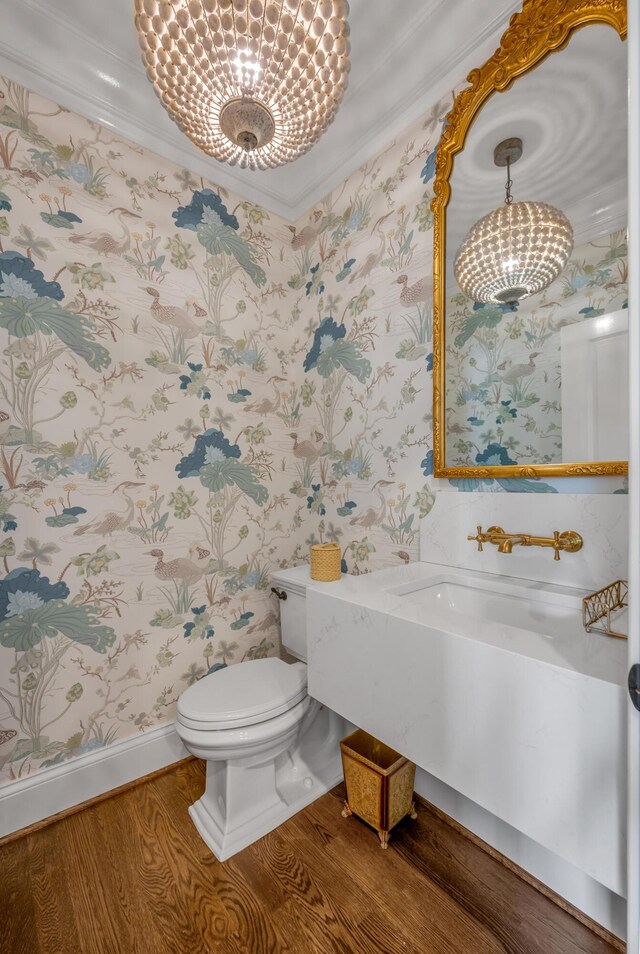 1775 Mooreland Dr, Lexington, KY 40502 - bathroom featuring a chandelier, wallpapered walls, ornamental molding, wood finished floors, and toilet