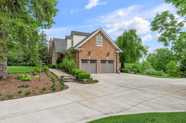 1775 Mooreland Dr, Lexington, KY 40502 - view of front facade featuring driveway, brick siding, an attached garage, a chimney, and a shingled roof