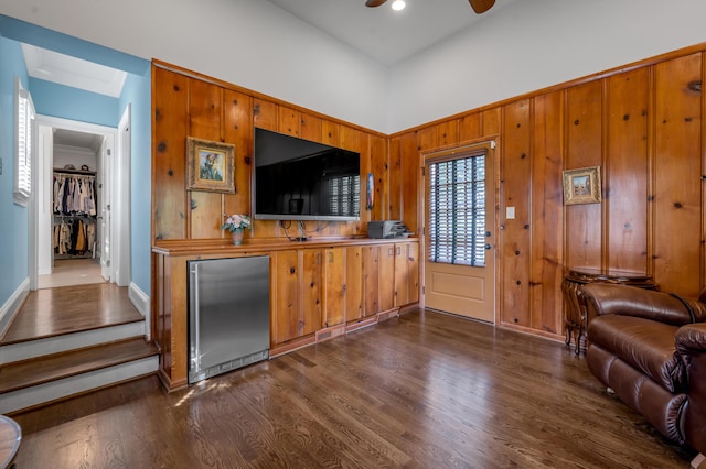1775 Mooreland Dr, Lexington, KY 40502 - bar with built in refrigerator, dark wood-type flooring, a ceiling fan, wood walls, and baseboards