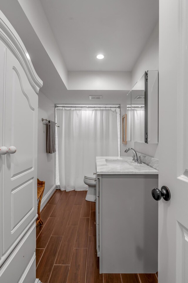 1775 Mooreland Dr, Lexington, KY 40502 - bathroom featuring toilet, wood finished floors, vanity, recessed lighting, and baseboards