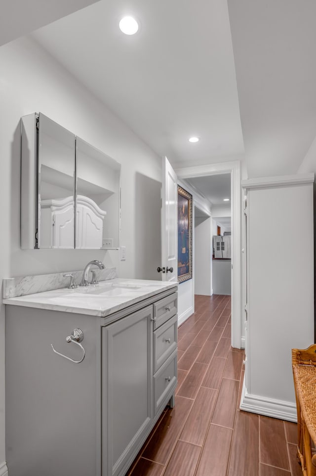 1775 Mooreland Dr, Lexington, KY 40502 - bathroom with wood finish floors, baseboards, recessed lighting, and vanity