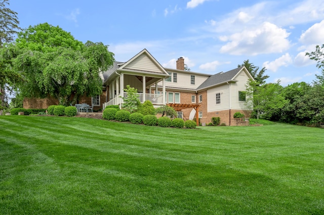 1775 Mooreland Dr, Lexington, KY 40502 - back of property featuring a chimney, brick siding, and a yard