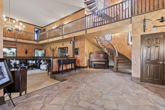 129 Adams Ln, Richmond, KY 40475 - interior space featuring baseboards, stairs, stone floors, a chandelier, and a towering ceiling