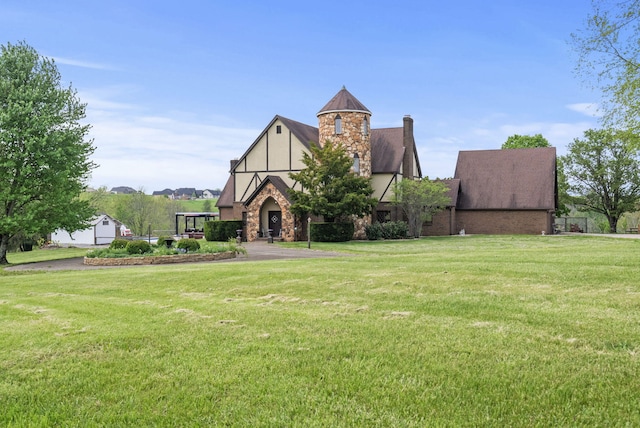 129 Adams Ln, Richmond, KY 40475 - tudor home featuring stone siding, stucco siding, a chimney, and a front yard