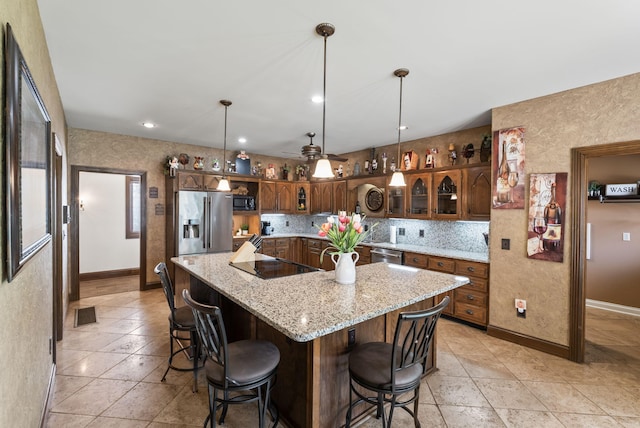 129 Adams Ln, Richmond, KY 40475 - kitchen with glass insert cabinets, a center island, baseboards, black appliances, and tasteful backsplash