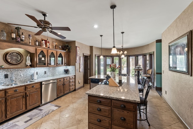 129 Adams Ln, Richmond, KY 40475 - kitchen featuring a sink, ceiling fan with notable chandelier, a breakfast bar area, a center island, and stainless steel dishwasher