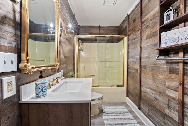 129 Adams Ln, Richmond, KY 40475 - bathroom featuring toilet, wood walls, vanity, and combined bath / shower with glass door