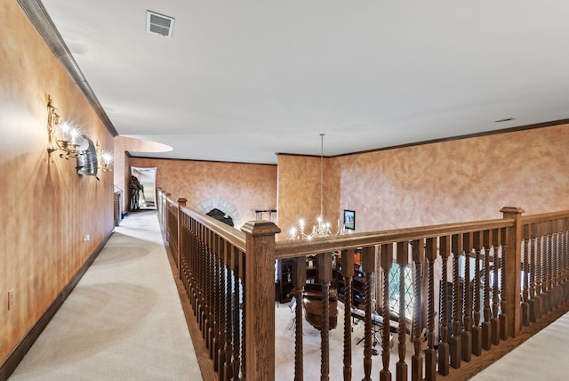 129 Adams Ln, Richmond, KY 40475 - hallway featuring ornamental molding, a chandelier, visible vents, and light colored carpet