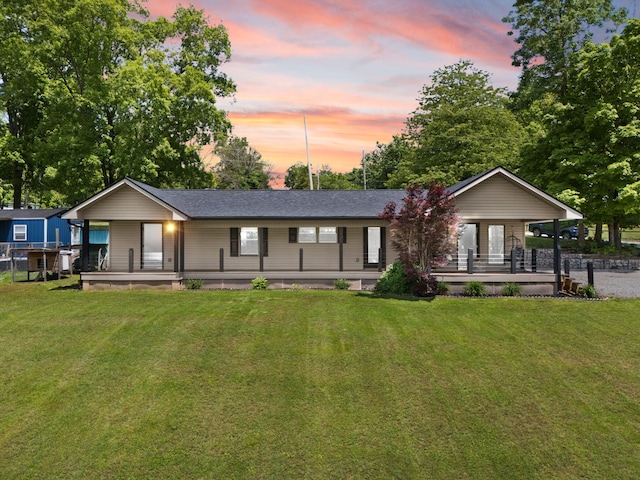 810 Lakeview Dr, Somerset, KY 42503 - back of property at dusk featuring covered porch and a yard