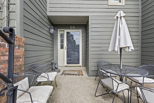 doorway to property with outdoor dining area and a patio