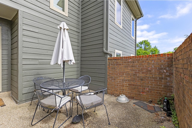 view of patio / terrace with outdoor dining space and fence