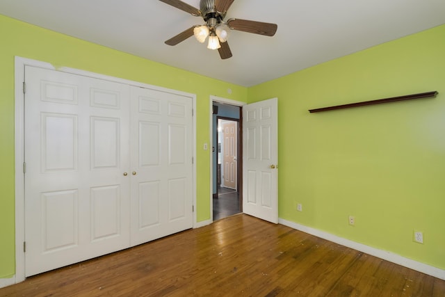 17590 New Columbus Rd, Corinth, KY 41010 - unfurnished bedroom featuring a closet, wood finished floors, baseboards, and a ceiling fan