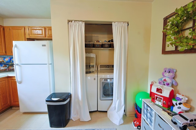 washroom featuring laundry area and separate washer and dryer