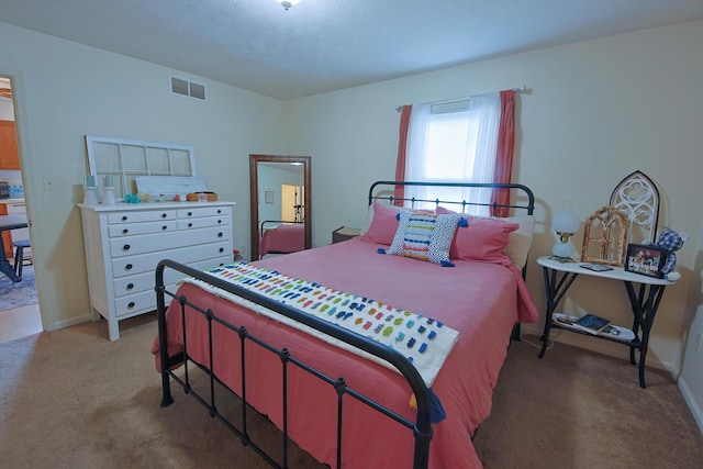 bedroom featuring light colored carpet, visible vents, and baseboards