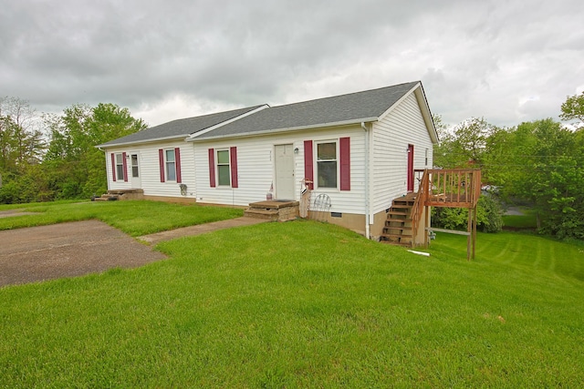 single story home featuring a deck, a shingled roof, a front lawn, and crawl space