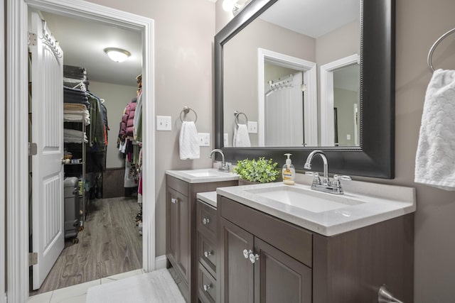 916 Auckland Ave, Richmond, KY 40475 - full bathroom with vanity, a spacious closet, and wood finished floors