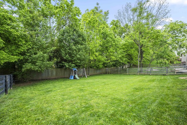 916 Auckland Ave, Richmond, KY 40475 - back of house featuring stairway, central air condition unit, a wooden deck, and brick siding
