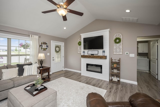 916 Auckland Ave, Richmond, KY 40475 - living area with washer / clothes dryer, a ceiling fan, vaulted ceiling, wood finished floors, and a large fireplace