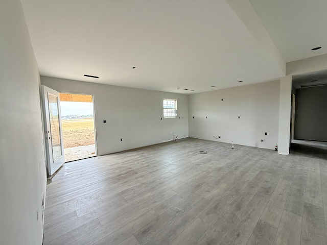 spare room with wood finished floors