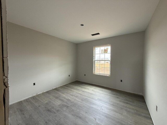 spare room with wood finished floors