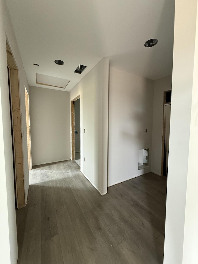 hall featuring attic access and wood finished floors