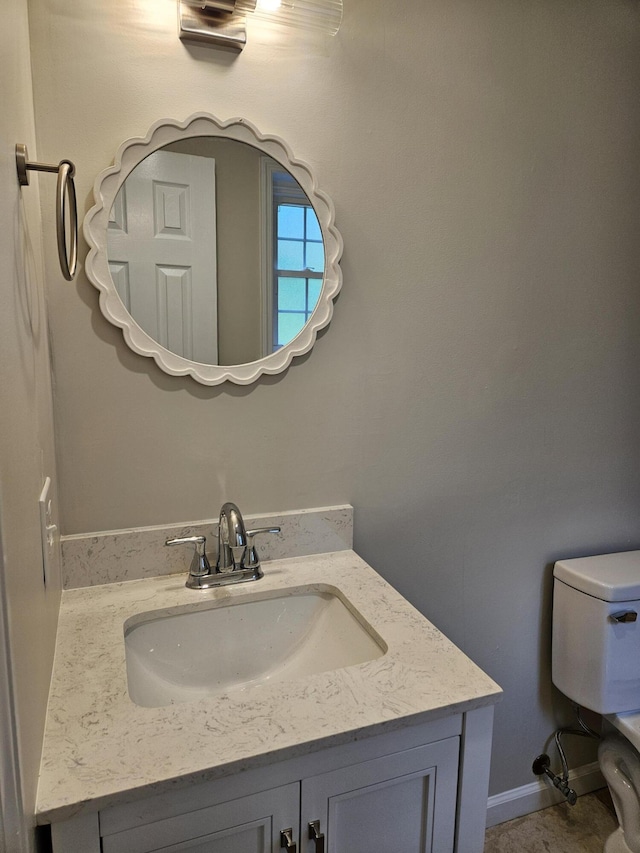 half bathroom featuring toilet and vanity