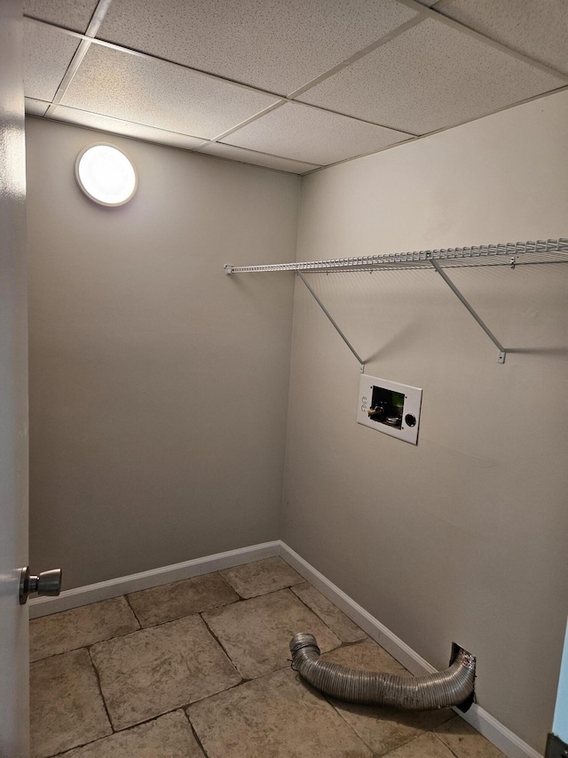 laundry area featuring washer hookup, baseboards, and tile patterned flooring