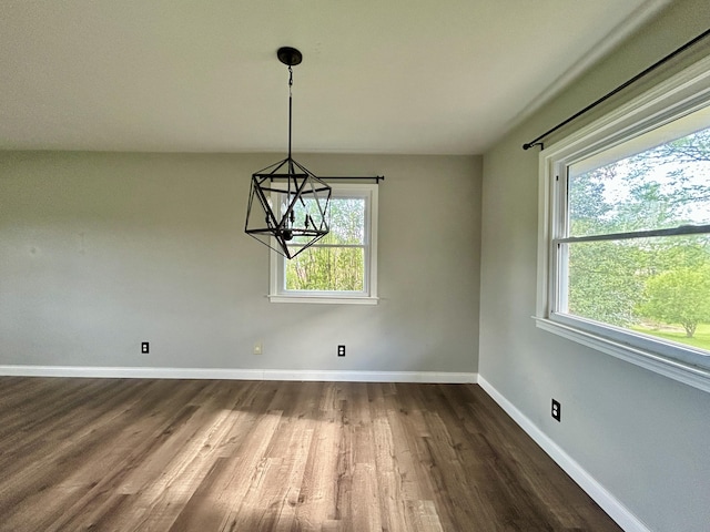 500 Meadowlark Dr, Somerset, KY 42503 - unfurnished dining area with a notable chandelier, baseboards, dark wood-style floors, and plenty of natural light