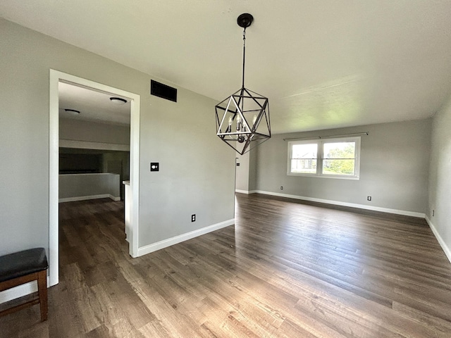 500 Meadowlark Dr, Somerset, KY 42503 - unfurnished dining area with an inviting chandelier, dark wood-type flooring, and baseboards