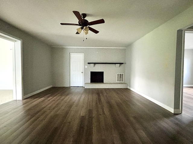 500 Meadowlark Dr, Somerset, KY 42503 - unfurnished living room featuring dark wood-type flooring, visible vents, ceiling fan, a brick fireplace, and baseboards