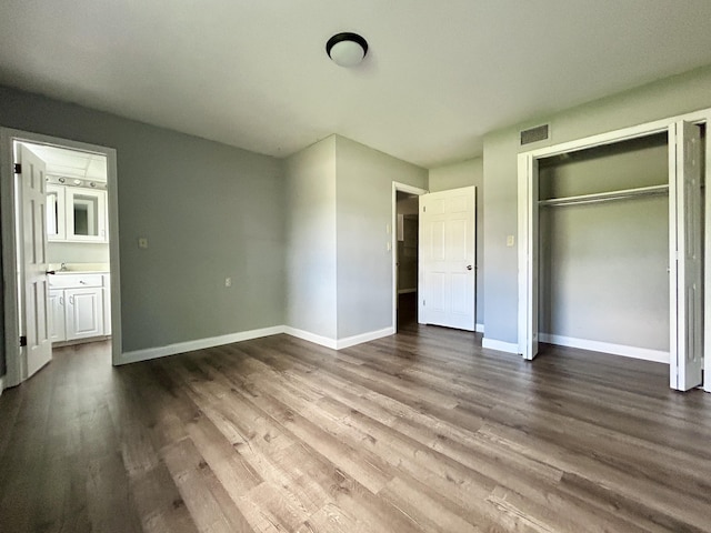 500 Meadowlark Dr, Somerset, KY 42503 - unfurnished bedroom with a closet, visible vents, baseboards, and dark wood-type flooring