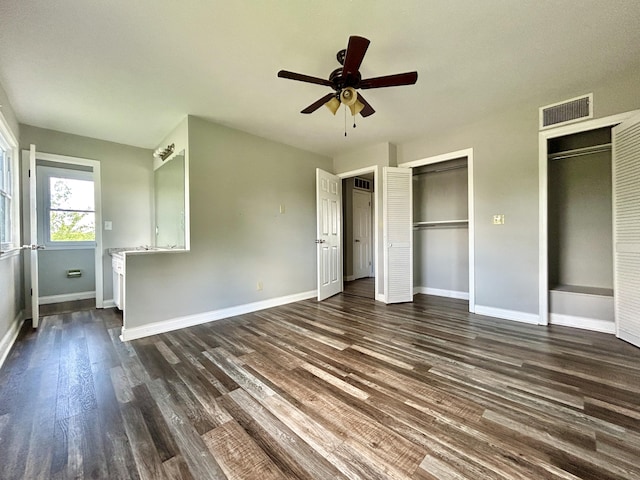 500 Meadowlark Dr, Somerset, KY 42503 - unfurnished bedroom featuring a ceiling fan, multiple closets, dark wood finished floors, visible vents, and baseboards