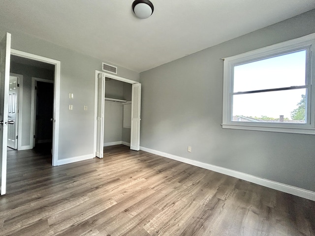 500 Meadowlark Dr, Somerset, KY 42503 - unfurnished bedroom with baseboards, a closet, visible vents, and wood finished floors