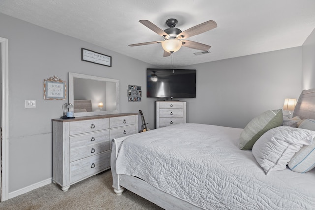 bedroom with light carpet, baseboards, and ceiling fan