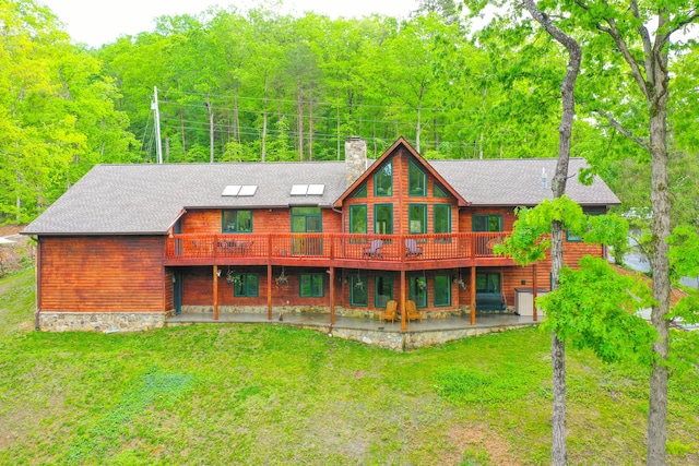 1117 Cliffs Edge Rd, East Bernstadt, KY 40729 - rear view of house with a chimney, a yard, roof with shingles, and a patio area