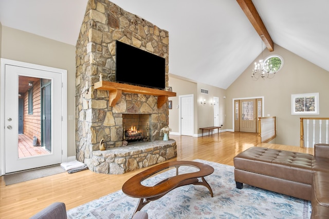 1117 Cliffs Edge Rd, East Bernstadt, KY 40729 - living room featuring wood finished floors, a chandelier, a stone fireplace, beamed ceiling, and high vaulted ceiling