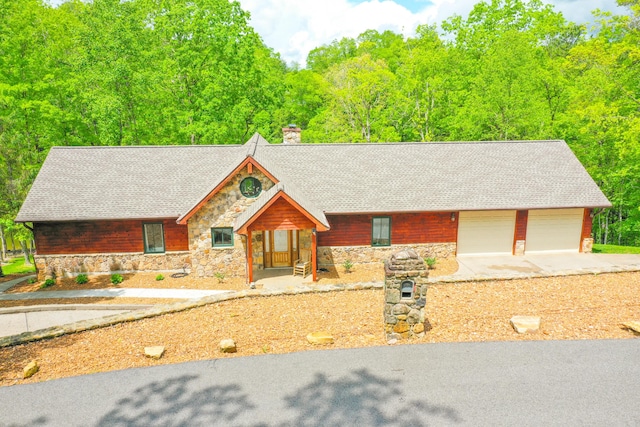 1117 Cliffs Edge Rd, East Bernstadt, KY 40729 - chalet / cabin featuring stone siding, a chimney, roof with shingles, and concrete driveway
