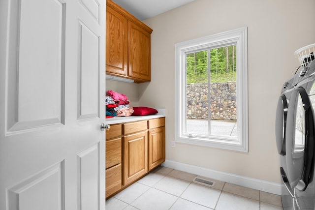 1117 Cliffs Edge Rd, East Bernstadt, KY 40729 - laundry area with cabinet space, baseboards, independent washer and dryer, and light tile patterned flooring