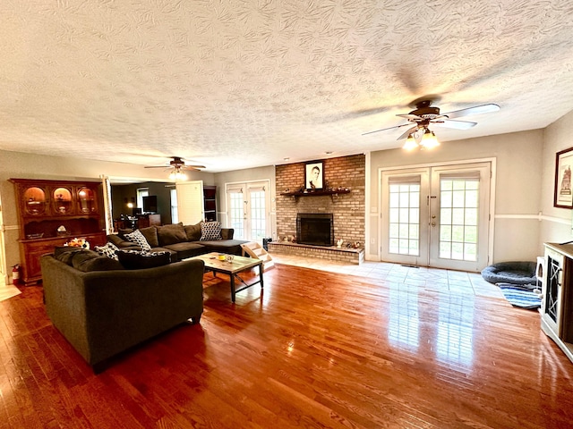 315 Sukey Hollow Rd, Williamsburg, KY 40769 - living area with a fireplace, ceiling fan, french doors, healthy amount of natural light, and a textured ceiling