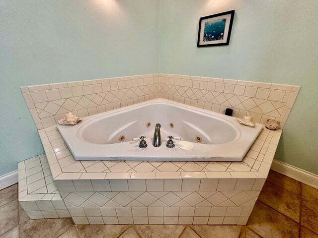315 Sukey Hollow Rd, Williamsburg, KY 40769 - bathroom featuring tile patterned flooring, a tub with jets, and baseboards
