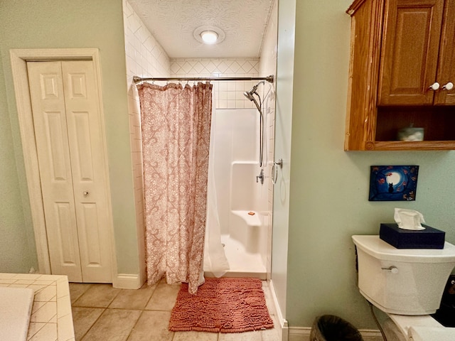 315 Sukey Hollow Rd, Williamsburg, KY 40769 - full bath with a shower stall, tile patterned flooring, a textured ceiling, a closet, and toilet