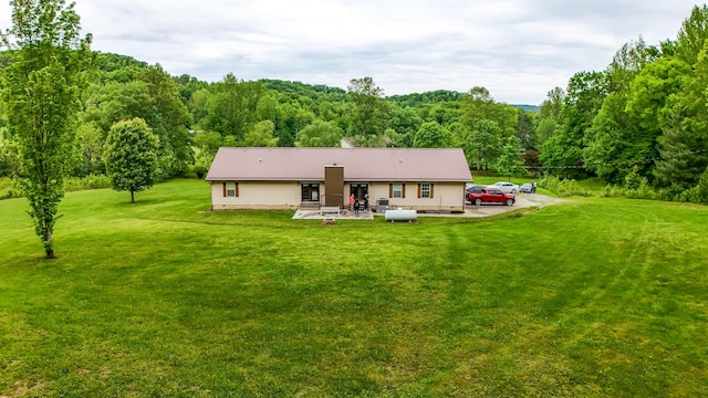 315 Sukey Hollow Rd, Williamsburg, KY 40769 - back of property with a forest view, a yard, and a patio