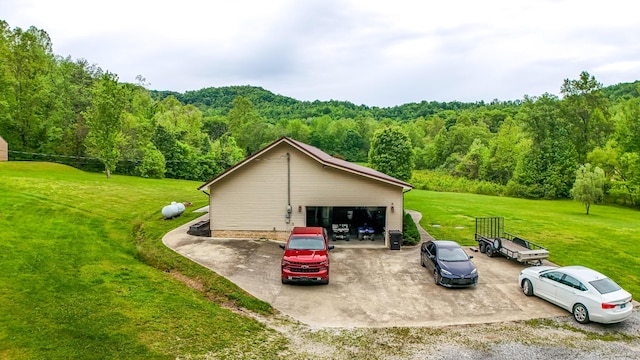 315 Sukey Hollow Rd, Williamsburg, KY 40769 - view of side of home with a forest view, a detached garage, a yard, and an outdoor structure
