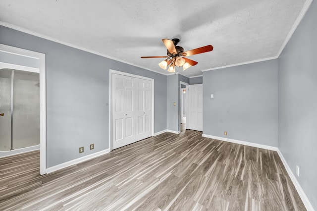 324 Circle Dr, Morehead, KY 40351 - unfurnished bedroom featuring wood finished floors, baseboards, a closet, ceiling fan, and a textured ceiling