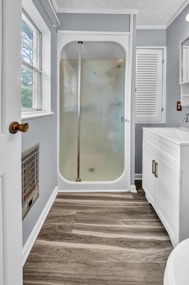 324 Circle Dr, Morehead, KY 40351 - bathroom with wood finished floors, a shower stall, crown molding, vanity, and baseboards