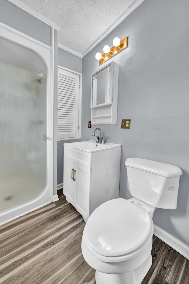 324 Circle Dr, Morehead, KY 40351 - bathroom with wood finished floors, a stall shower, toilet, crown molding, and vanity
