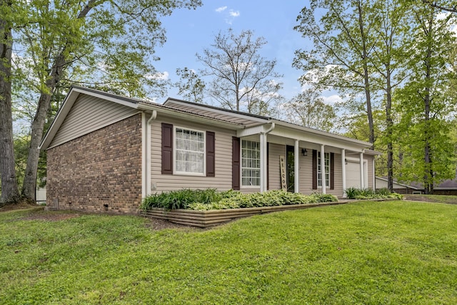 324 Circle Dr, Morehead, KY 40351 - view of front of house featuring a front lawn, a garage, and brick siding