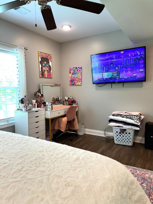 bedroom with wood finished floors, baseboards, and ceiling fan